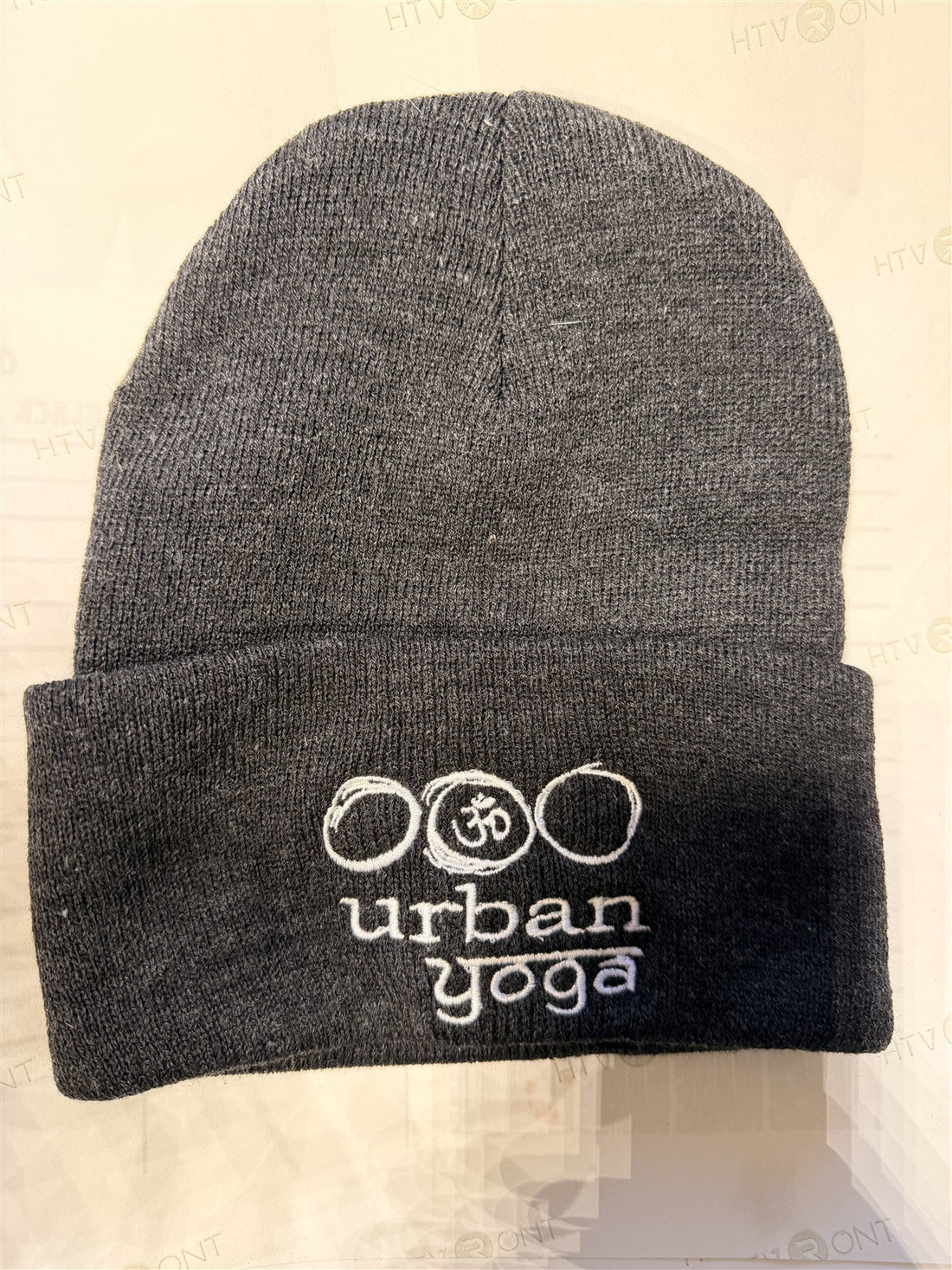 Charcoal cuffed knit beanie with a white embroidered logo on the cuff, decorated by Battle Born Clothing in Yerington, NV